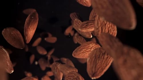 Falling Almonds on Dark Background - Food Close Up
