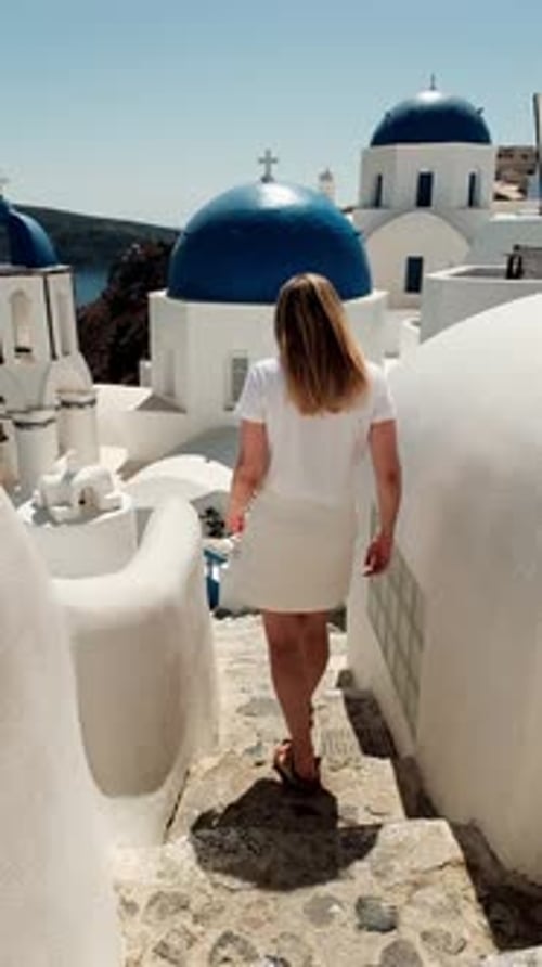 Woman Walking Through Bright White Urban Setting