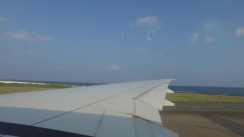 Airplane Wing Gathering Speed on Runway
