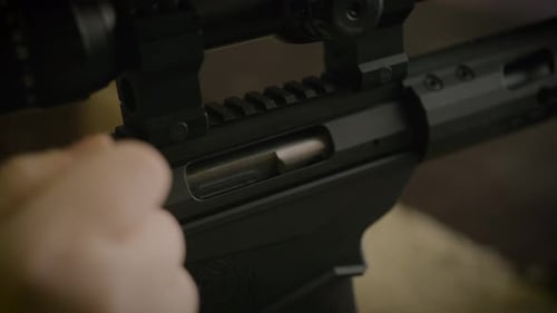 Shooter reloading bolt action rifle, close up on cartridge ejected