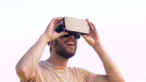Man Wearing a VR Headset Smiling Outdoors