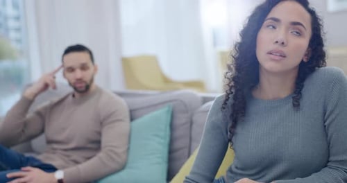 Woman Talking, Man Lying on Sofa