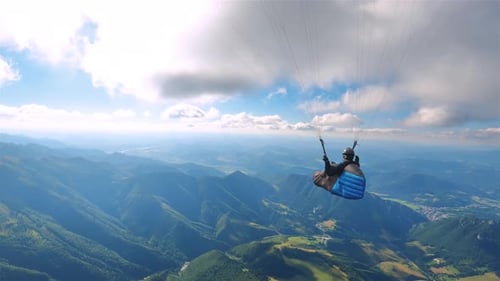 Peaceful Paragliding Flying Over Green Mountains