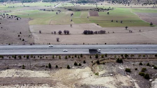 Aerial view cars on the highway in the field 4K
