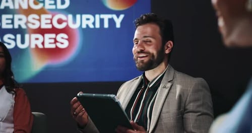 Tablet, presentation and business people in discussion on a stage for enhanced cybersecurity