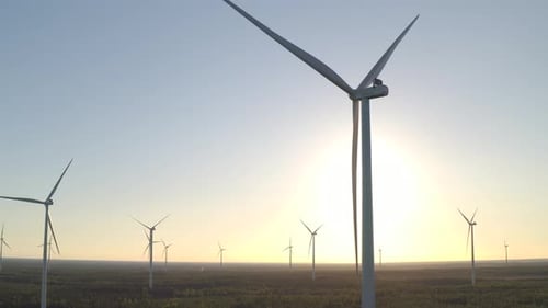 Wind farm panning shot during sunset in the afternoon, outdoor landscape of scenic wind turbines dur