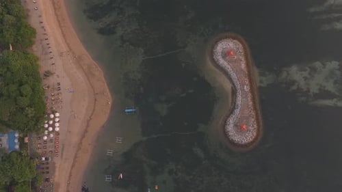Aerial view of beach with moored boats and umbrellas, Sanur, Bali, Indonesia.