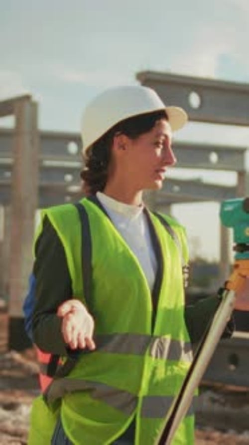 Construction Engineer Guides Team Female Construction Engineer Demonstrates Precise Measurement