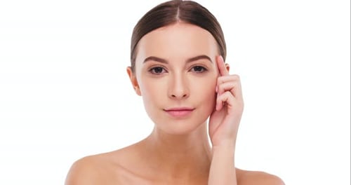 Elegant Woman Touching Face in Studio Portrait