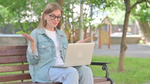Young Woman Doing Video Call on Laptop in Park
