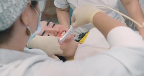 Dentist Examines Woman's Teeth With Dental Equipment