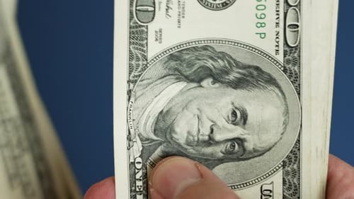 Cashier engaged in counting united states dollar bills