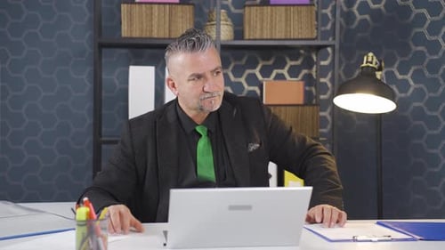 Man Working at Laptop in Modern Office