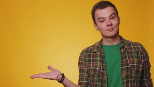 Young Man Pointing Empty Place Advertising Area for Commercial Text Copy Space for Goods Promotion