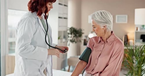 Doctor, blood pressure and senior woman in office, consultation and conversation with healthcare