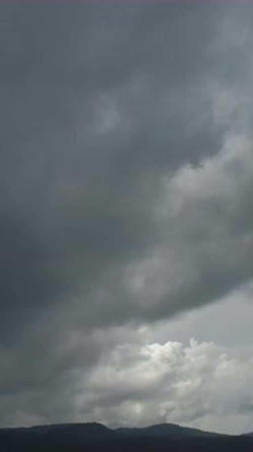 Ominous Gray Clouds Rolling Over Mountain Range