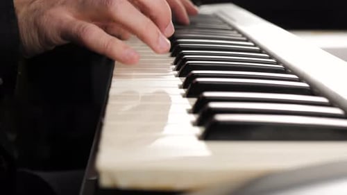Hands Play Music on White Electric Piano