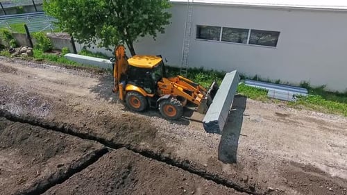 Tractor on construction site. Aerial view of tractor machine on construction site