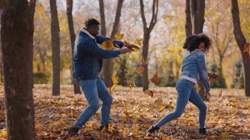 Happy Boyfriend Runs to Hug Beloved Girl After Game with Leaves