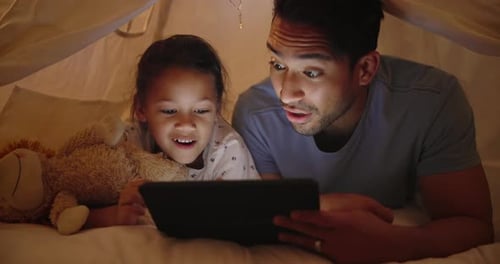 Father and Daughter Play on Tablet in Tent