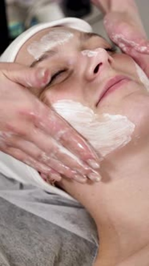 Woman Receiving Facial Treatment at Spa