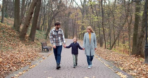 Happy Young Family of Caring Beautiful Blonde Mom Handsome Bearded Loving Dad and Cute Little Son