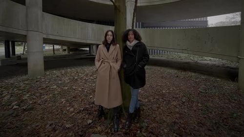 Lifestyle Portrait of Two Young Women Watching Tower Building Together