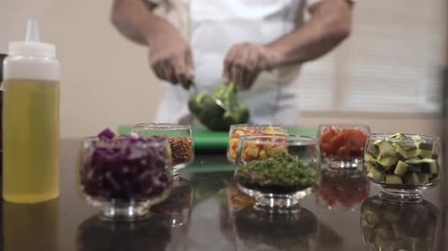 Chef cutting broccoli with knife in kitchen. Professional cutting of broccoli. Slicing of broccoli.