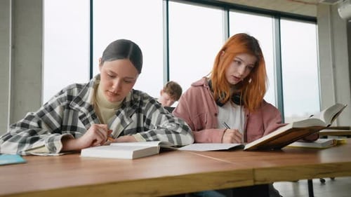 Happy Young University Students Studying with Books in Classroom Back to School