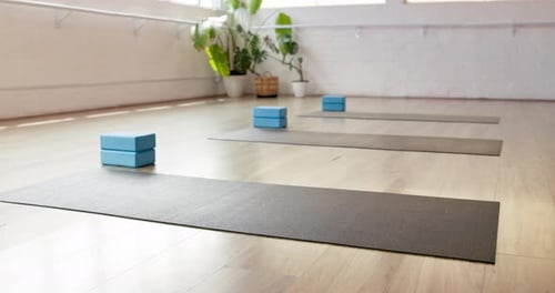 Fitness, yoga and mat in gym on floor, preparation and equipment for body wellness class