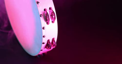 Close-up Tambourine in Studio with Pink Smoke