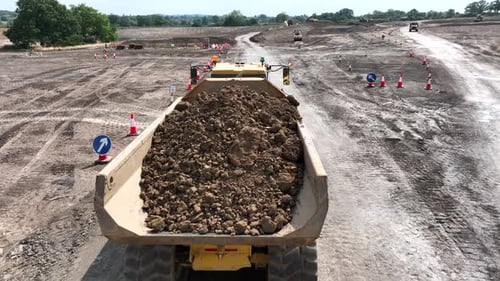Dump Truck Moving Dirt at Construction Site