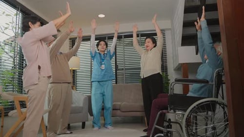 Seniors Exercising with Healthcare Worker in Home