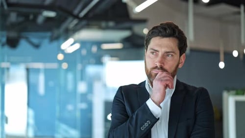 Businessman Thoughtfully Planning in Modern Office