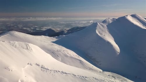 Aerial View of Frozen Snowy Mountains in Winter Alps Landscape