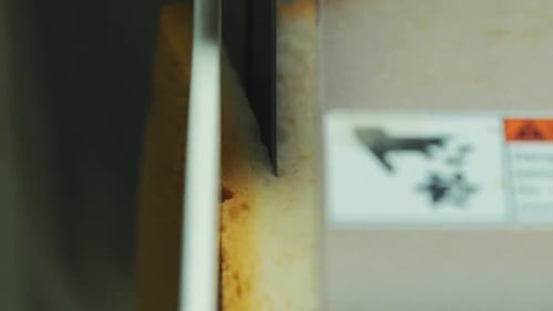 bread cutting cuts square bread. close up shot