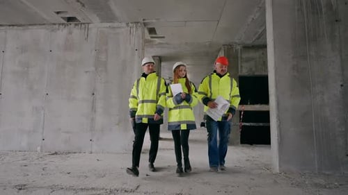 Three Building Inspectors are Examining Building Under Construction Architects and Female Engineer