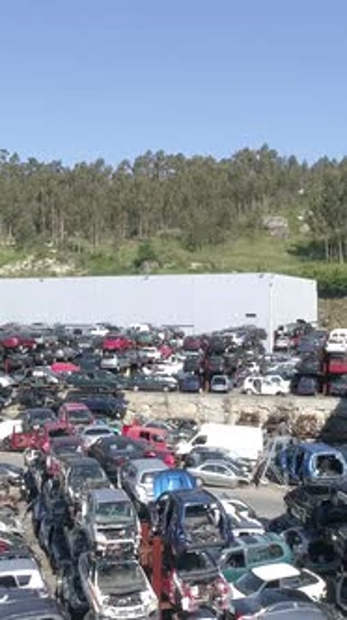 Vertical Video of Large Diversity of Damaged Cars Waiting a Junkyard