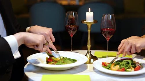 Happy Man and Woman Eating Salads While Having Romantic Dinner in the Restaurant Lifestyle Love