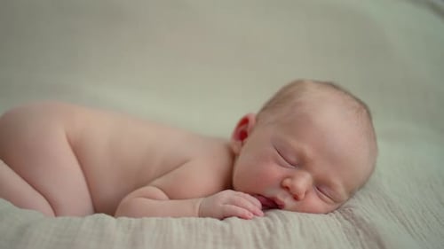 Infant Sleeping Peacefully on a Blanket Close Up