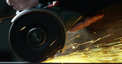 .blacksmith or welder,with its grinding smooths steel and iron,in extreme slow motion,to make the