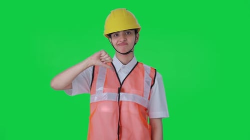 Upset Indian female architect showing thumbs down Green screen