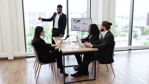 Business Team Discussing Analytics During a Meeting in Modern Office