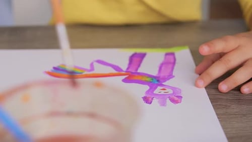 Childhood, Creativity And Art Concept - Hands Of Little Girl Drawing Picture With Colors And Brus...