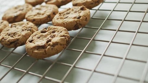 Video of rows biscuits on a baking rack over white background