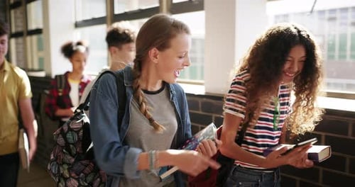 Education, phone and girl students walking in a hallway at school, talking