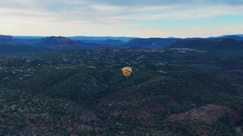 Evergreen National Forest With Soaring Hot Air Balloon During Sunrise In Sedona, Arizona, USA. Aeria
