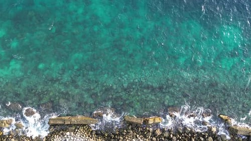 aerial view of pebble beach with blue sea
