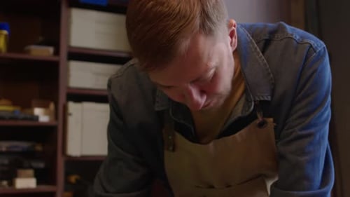 Caucasian Man Woodworking in Workshop