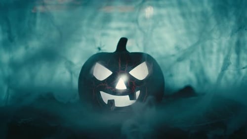 Glowing Pumpkin with Mysterious Gloved Hand and Smoke